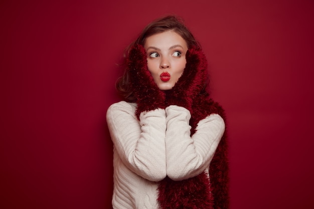 Young woman in knitted sweater send kiss