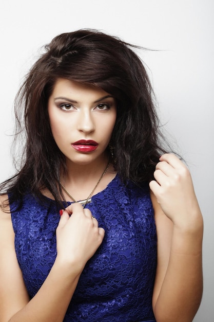 Young woman l looking at camera over white background