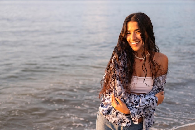 Young woman laughing happily at the beach