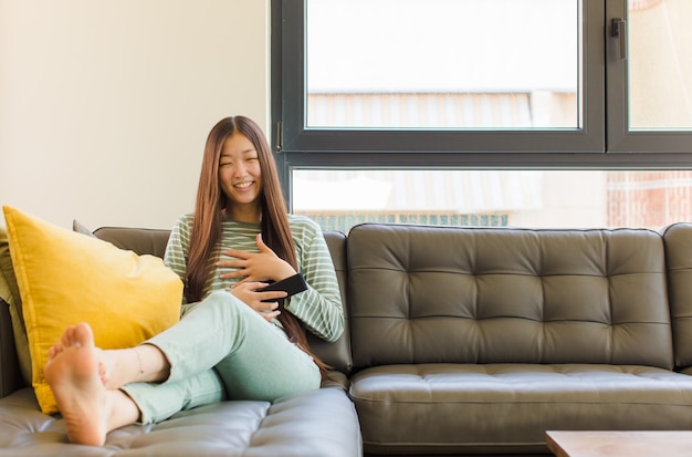 Young woman laughing out loud at some hilarious joke