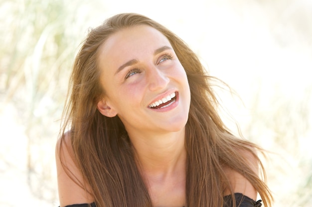 Young woman laughing outdoors