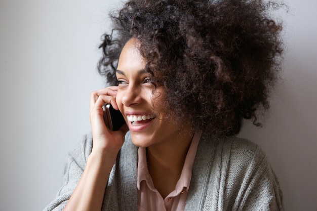 young woman laughing and talking on mobile phone