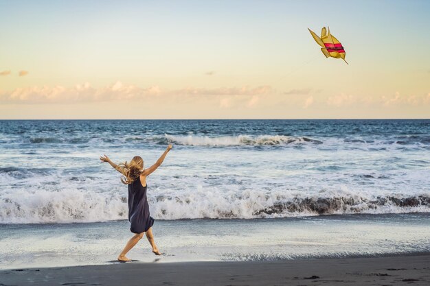 A young woman launches a kite on the beach Dream aspirations future plans