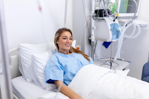 Young woman laying on bed at hospital ward medicine health care and quarantine concept female patient lying in bed in hospital ward