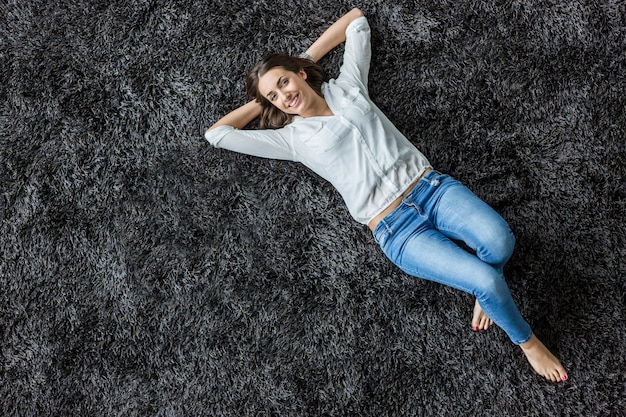 Young woman laying on the carpet