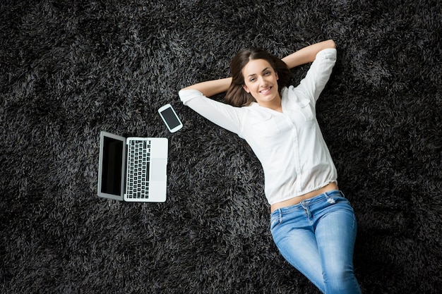 Young woman laying on the carpet