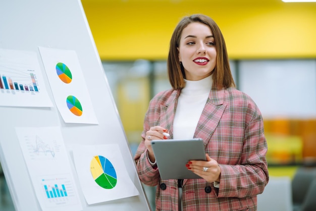 young woman leader presenter make a business presentation at a conference in the office