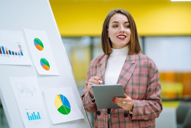 Young woman leader presenter make a business presentation at a conference in the office