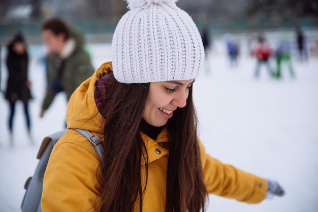 Young woman learn to ski at city ice rink