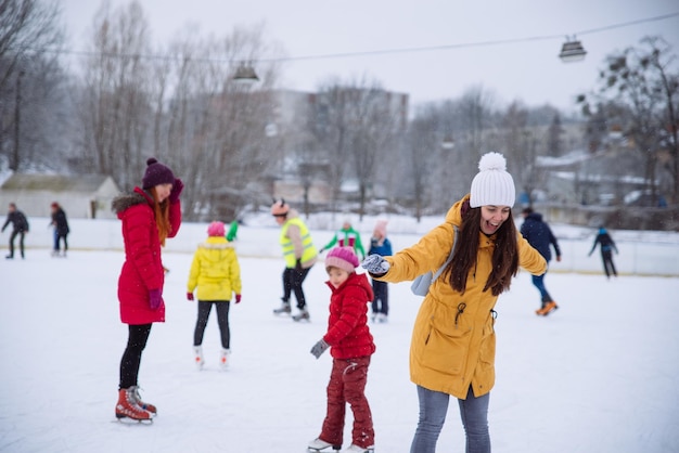 Young woman learn to ski at city ice rink