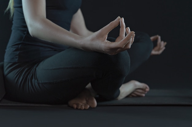 Young woman legs practicing yoga on yoga mat