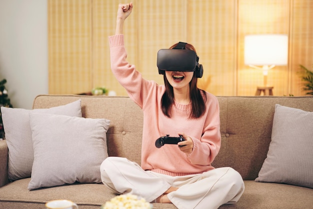 Young woman lesbian wearing sweater and VR goggles while holding