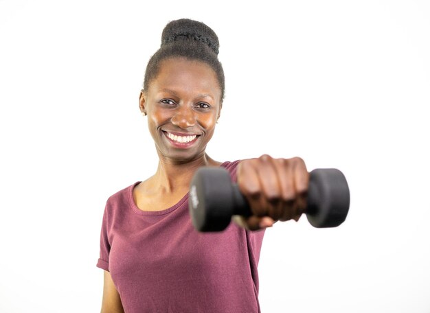 Young woman lifting a dumbbell isolated on white background