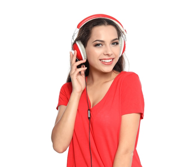 Young woman listening to Christmas music on white background