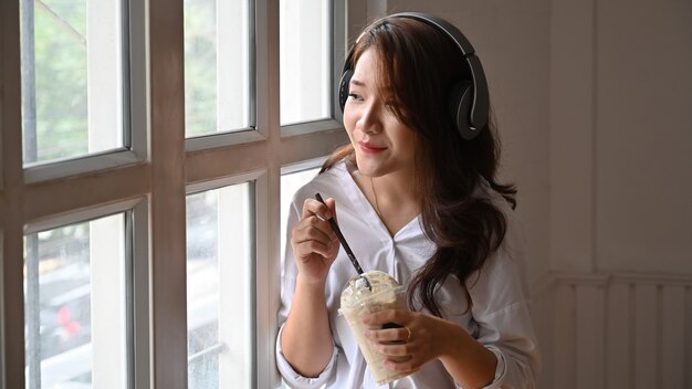 Young woman listening to music and enjoy songs