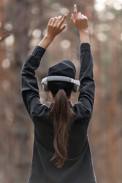 Foto giovane donna che ascolta la musica nella foresta