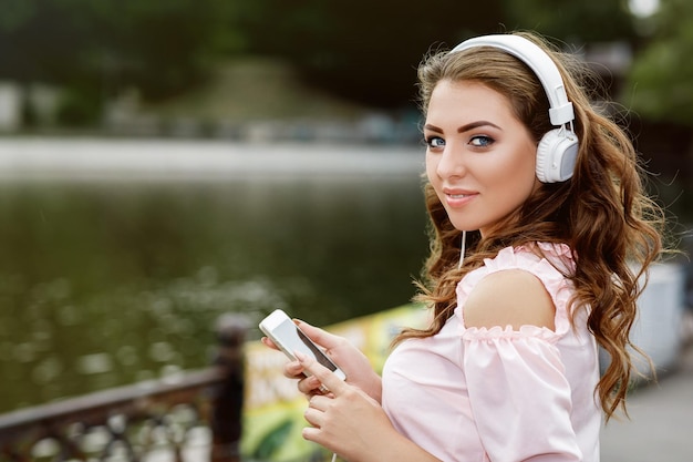 Young woman listening to music on headphones