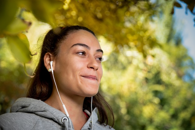 Young woman listening to music during training session