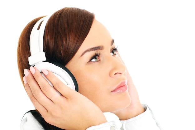 a young woman listening to music over whie background