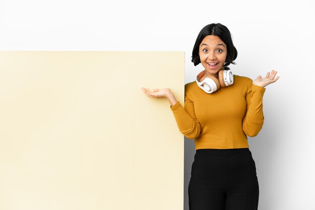 Young woman listening music with a big empty placard isolated