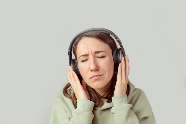 Young woman listening to music with headphones