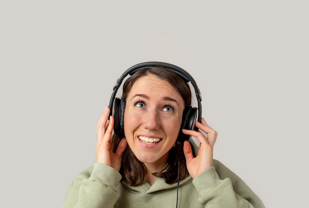 Young woman listening to music with headphones