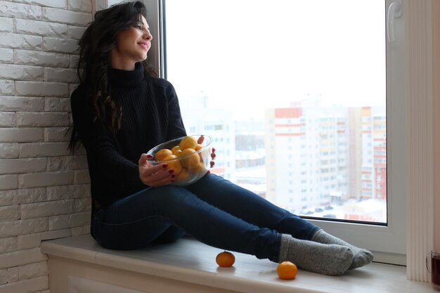 A young woman look on the window