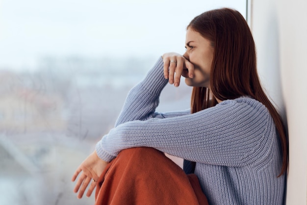 Young woman looking away while sitting outdoors