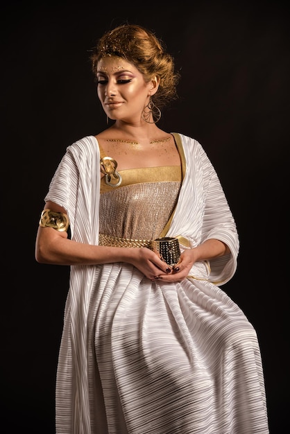 Young woman looking away while standing against black background