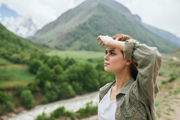 Young woman looking away while standing on mountain