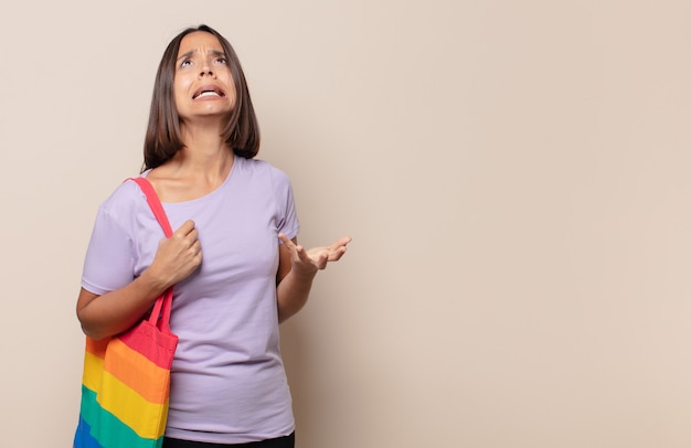 Young woman looking desperate and frustrated, stressed, unhappy and annoyed, shouting and screaming