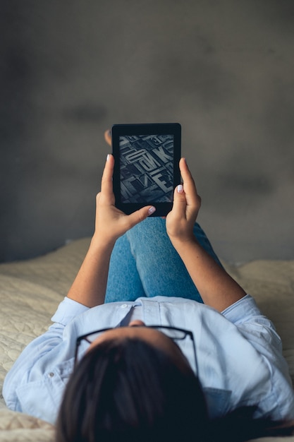 Young woman looking ebook