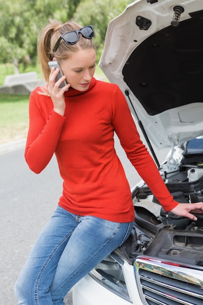 Young woman looking at engine