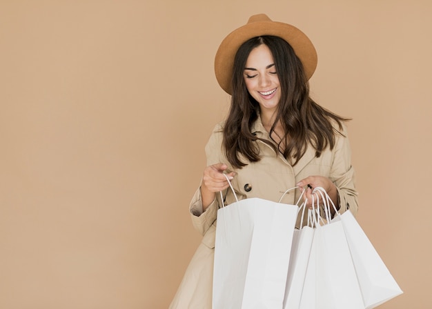 Young woman looking inside shopping bags