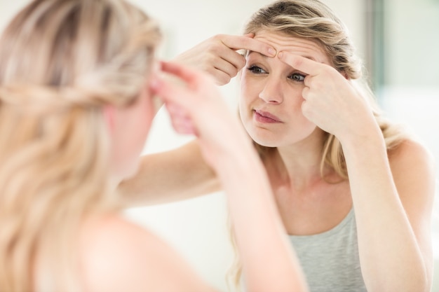 Young woman looking in mirror