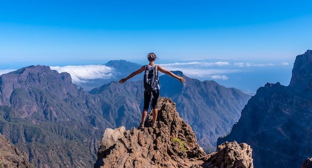 A young woman looking out from the top of the Caldera de Taburiente volcano