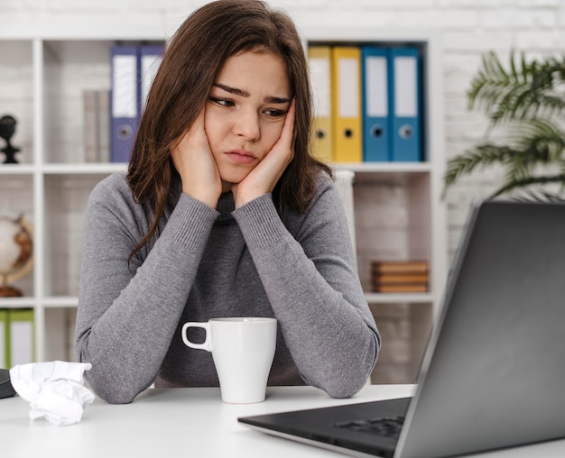 young woman looking sad while working from home