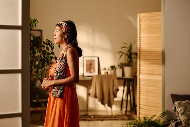 Young woman looking through window