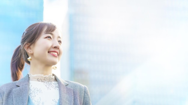 A young woman looking up at the sky in the city