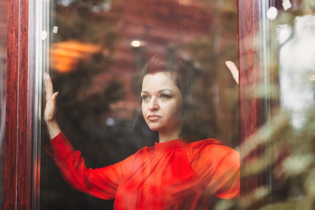 A young woman looks out the window. Thoughts on the important