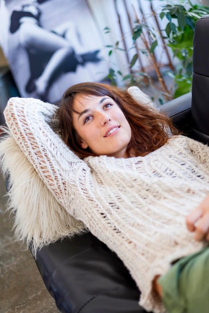 Young woman lying on sofa at home