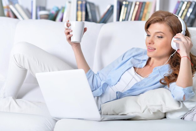 Young woman lying with laptop