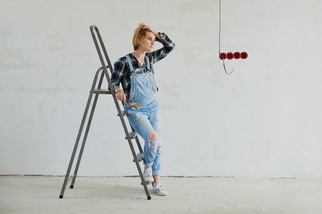 Young woman makes repairs in her house