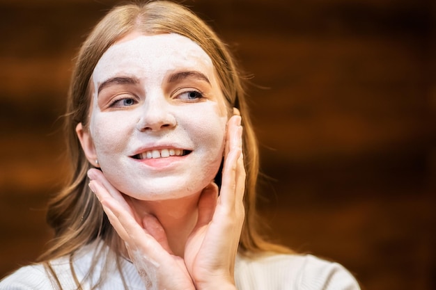 Young woman making a face mask