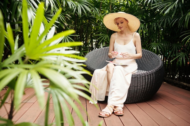 Young woman making herbarium outdoors