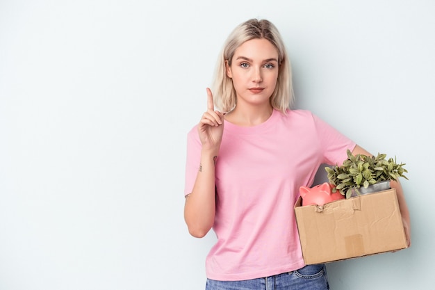 Young woman making a move over isolated background showing number one with finger.