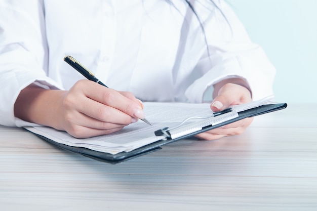 Young woman making notes in a clipboard