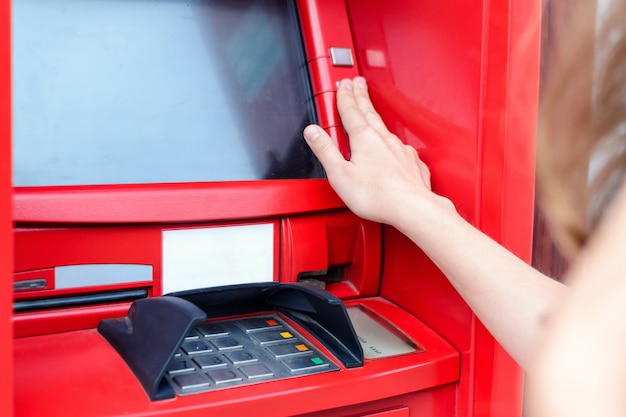 Young woman making payment at ATM