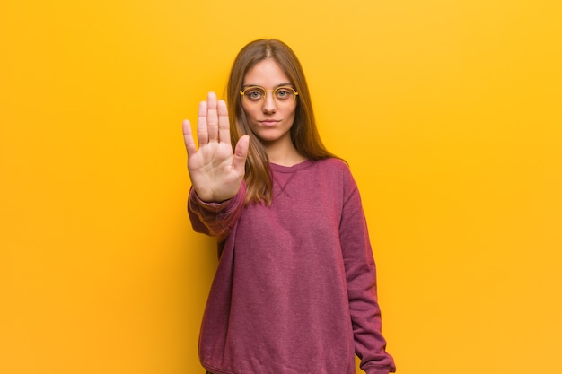 Young woman making stop sign