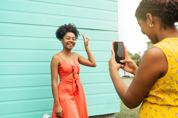 Young woman making for a video in front of a camera phone